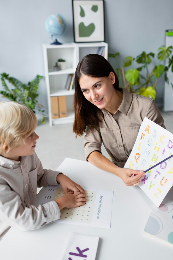 Speech therapist guiding a young girl through mouth movement exercises during a speech therapy session